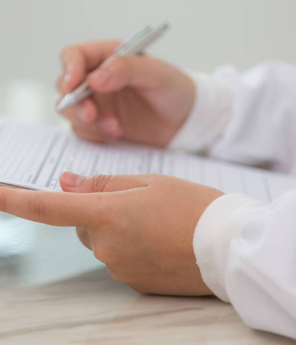 Hand of doctor writing on prescription